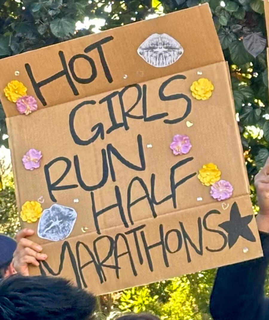 Handmade race day sign reading Hot Girls Run Half Marathons
